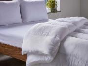 10.5 tog soft hollowfiber duvet on a solid walnut wood bed