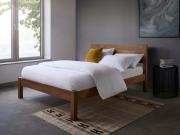 Luxury white bedding set with duvet cover and pillowcases on minimalist wooden bed, premium cotton bedding for modern bedroom decor.
