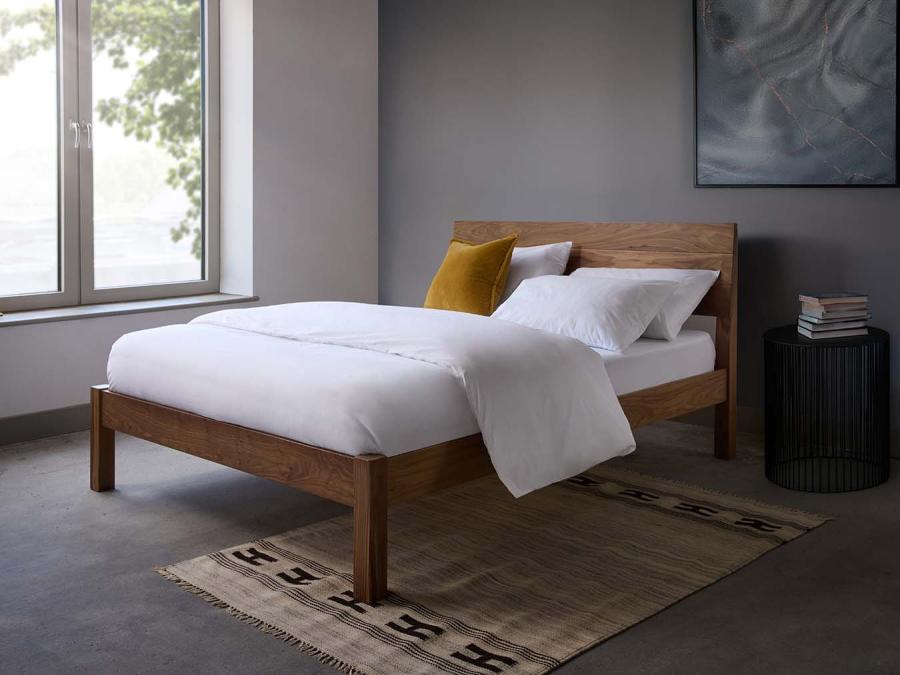 Luxury white bedding set with duvet cover and pillowcases on minimalist wooden bed, premium cotton bedding for modern bedroom decor.