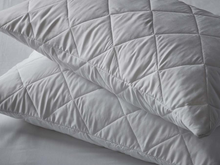 Two pinsonic pillow protectors on pillows