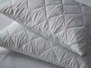 Two pinsonic pillow protectors on pillows