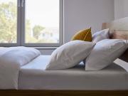 Soft bedding on wooden bed
