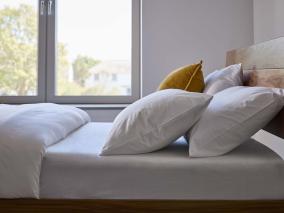 Soft bedding on wooden bed